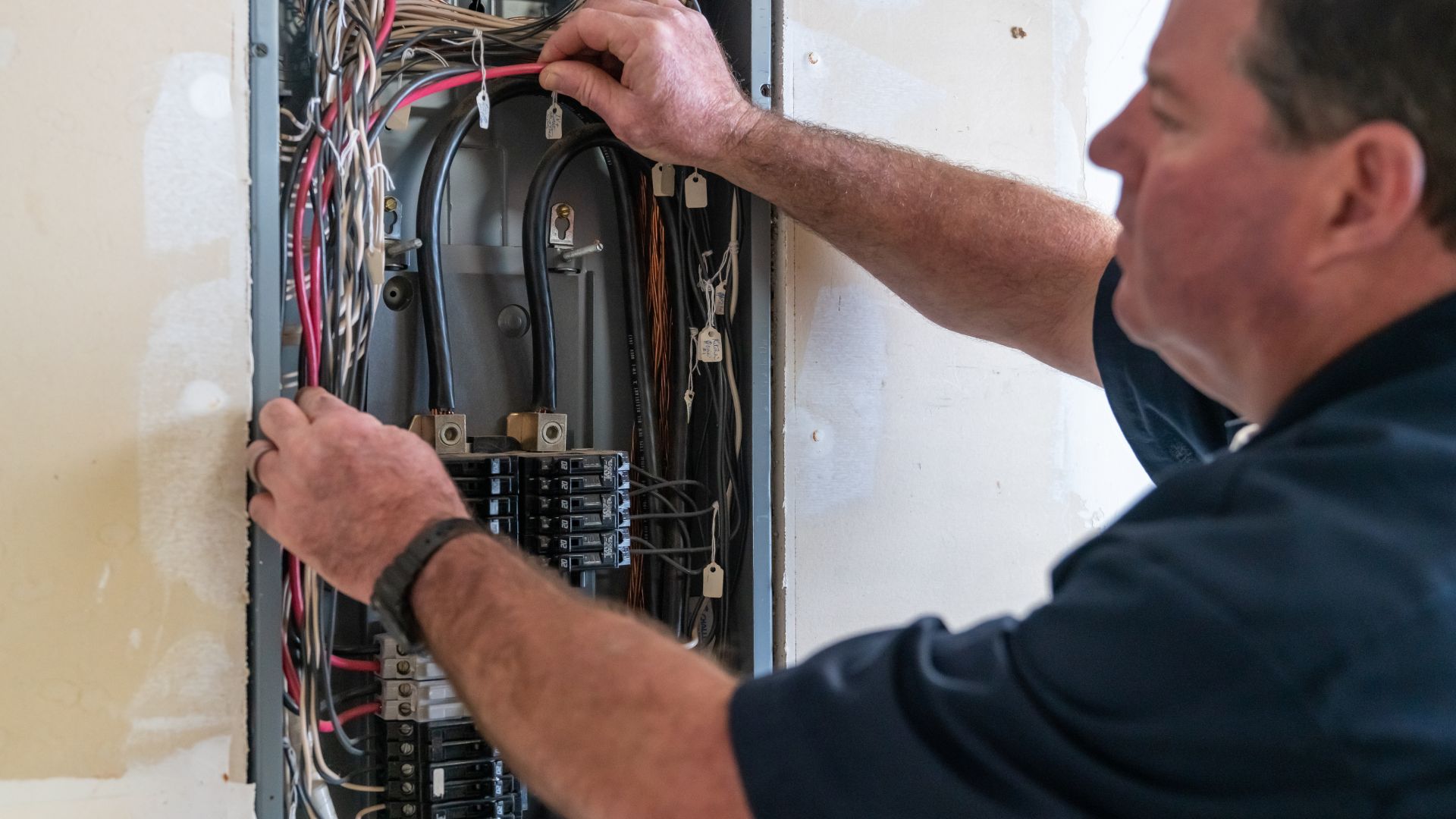 Electrician working on a service panel